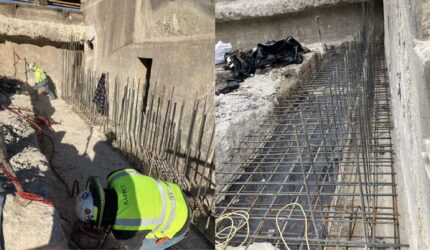 Construction workers setting up formwork for concrete pouring during the Lake McQueeney Dam renovation to reinforce the foundation.